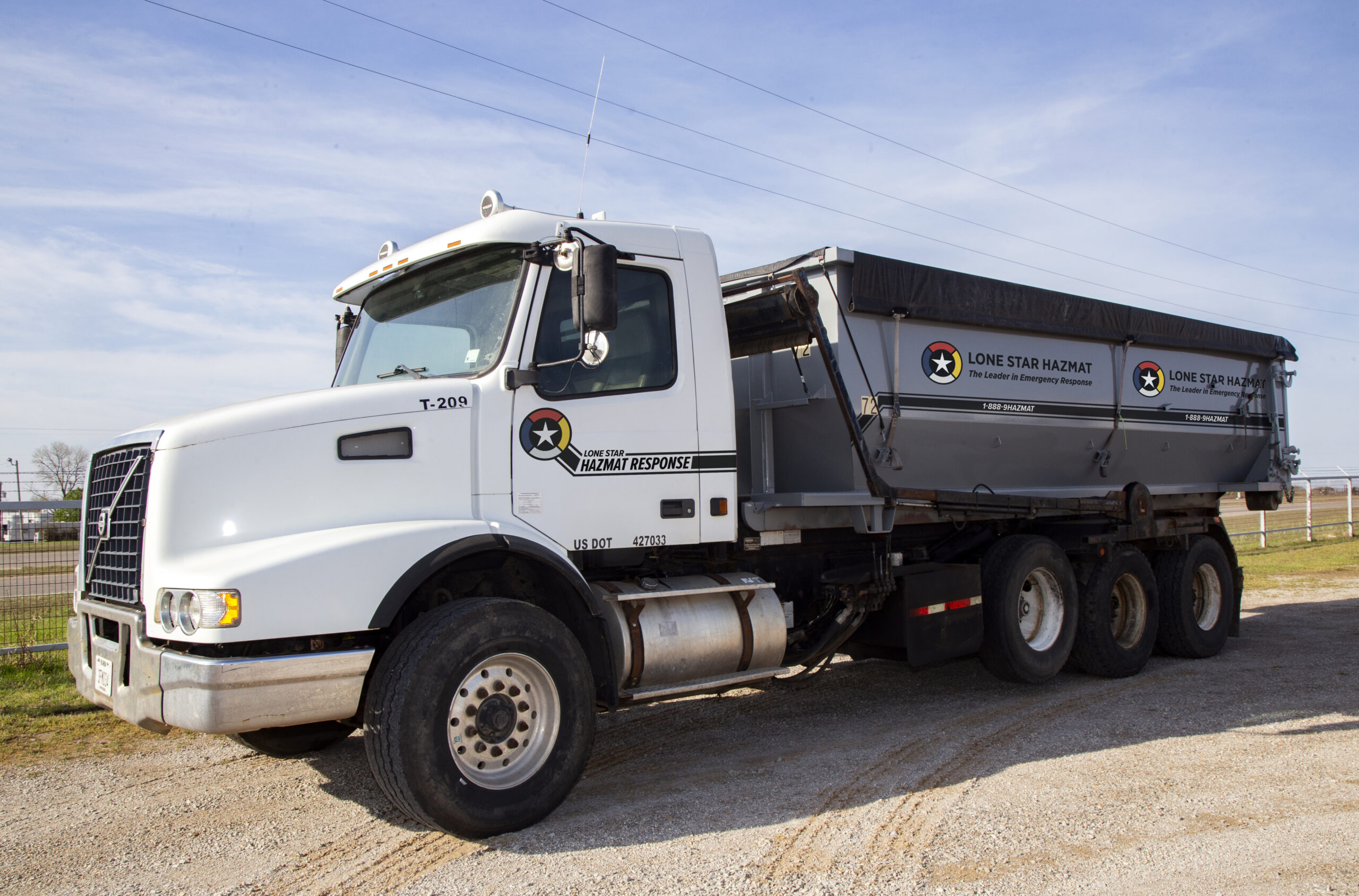 Lone Star Hazmat rolloff container truck for industrial waste management and hazmat transportation services